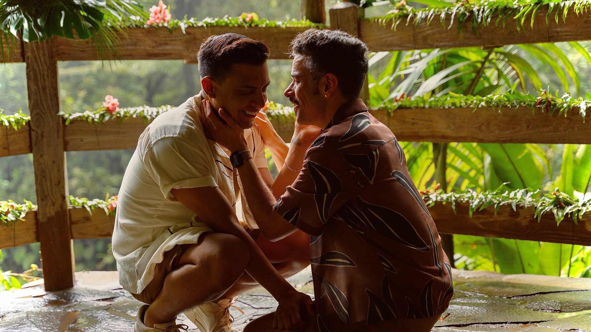 Alex and Andrew sharing a happy moment together in a lush garden